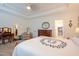Spacious bedroom features a decorative quilt, tray ceilings, and classic furnishings at 150 Red Admiral Ct, Hillsborough, NC 27278