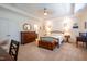 Spacious bedroom features a decorative quilt, tray ceilings, and classic furnishings at 150 Red Admiral Ct, Hillsborough, NC 27278