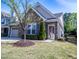 Inviting home showcasing stone facade, manicured lawn, and cozy front porch at 150 Red Admiral Ct, Hillsborough, NC 27278