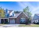 Charming home featuring stone accents, attached garage, and well-maintained landscaping at 150 Red Admiral Ct, Hillsborough, NC 27278