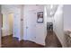 Bright hallway features hardwood floors and white doors leading to other rooms, including one to a laundry room at 150 Red Admiral Ct, Hillsborough, NC 27278