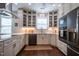 A well-lit kitchen with white cabinets, stainless steel appliances, and quartz countertops at 150 Red Admiral Ct, Hillsborough, NC 27278