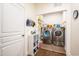 Convenient laundry room with modern washer and dryer, storage shelves, and practical organization solutions at 150 Red Admiral Ct, Hillsborough, NC 27278
