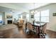 Open-concept living and dining area with hardwood floors and abundant natural light at 150 Red Admiral Ct, Hillsborough, NC 27278