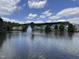 Scenic view of the community pond with a fountain, surrounded by well-maintained landscaping and charming homes at 150 Red Admiral Ct, Hillsborough, NC 27278