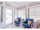 Relaxing sunroom with bright windows, cozy seating, and peaceful views to bring the outside in at 150 Red Admiral Ct, Hillsborough, NC 27278