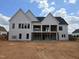 Backyard view of a modern white home with unfinished patio at 154 Bellini Dr, Clayton, NC 27527