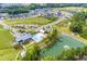 Aerial view of the community pool, clubhouse, playground, pond, and neighborhood at 1577 Wendell Valley Blvd, Wendell, NC 27591