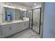 Modern bathroom with dual sinks, large mirror, and sleek walk-in shower at 1577 Wendell Valley Blvd, Wendell, NC 27591