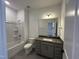 Well-lit bathroom with tiled floors, a vanity, and a shower-tub combo, creating a functional space at 1577 Wendell Valley Blvd, Wendell, NC 27591