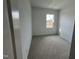 A bright bedroom featuring neutral carpet and a window that allows natural light to fill the space at 1577 Wendell Valley Blvd, Wendell, NC 27591