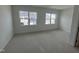 Carpeted bedroom filled with natural light from two large windows at 1577 Wendell Valley Blvd, Wendell, NC 27591