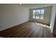 Bright bedroom features hardwood floors and a large window with neighborhood view at 1577 Wendell Valley Blvd, Wendell, NC 27591