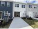 A driveway leads to a spacious garage in this modern townhome community at 1577 Wendell Valley Blvd, Wendell, NC 27591