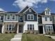 Beautiful townhome featuring stone accents, a covered porch, and complementary siding at 1577 Wendell Valley Blvd, Wendell, NC 27591