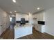 Modern kitchen boasts white cabinets, stainless appliances, and a center island at 1577 Wendell Valley Blvd, Wendell, NC 27591