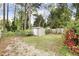 Backyard featuring a storage shed, fenced perimeter, and natural landscaping, providing ample outdoor space at 2008 Reaves Dr, Raleigh, NC 27608