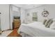 Cozy bedroom with a dresser, TV, and natural light coming through the window at 2008 Reaves Dr, Raleigh, NC 27608