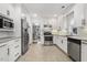 Spacious kitchen with stainless steel appliances, granite countertops, and convenient tile flooring at 2008 Reaves Dr, Raleigh, NC 27608