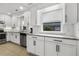 Modern kitchen with stainless steel appliances, white cabinets, granite countertops, and tile flooring at 2008 Reaves Dr, Raleigh, NC 27608