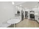 Bright kitchen with a cozy eating nook, stainless steel appliances, granite countertop and white cabinetry at 2008 Reaves Dr, Raleigh, NC 27608
