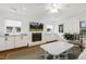 Bright living room featuring a brick fireplace, built-in cabinets, and hardwood floors at 2008 Reaves Dr, Raleigh, NC 27608
