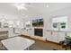 Open-concept living area with fireplace and built-ins, seamlessly flowing into the modern kitchen at 2008 Reaves Dr, Raleigh, NC 27608