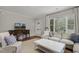 Bright living room featuring a large window, neutral furniture, and a stylish accent table at 2008 Reaves Dr, Raleigh, NC 27608