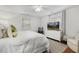 Inviting main bedroom with a TV, cozy rug, and windows that fill the room with natural light at 2008 Reaves Dr, Raleigh, NC 27608