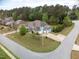 Stunning aerial view of a blue house with a large yard, complemented by mature trees and landscaping at 201 Blue Heron Dr, Youngsville, NC 27596