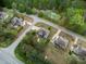Serene aerial shot of a neighborhood featuring a light-blue house and lush greenery, and community layout at 201 Blue Heron Dr, Youngsville, NC 27596