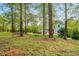 Serene backyard featuring a bench, a stone firepit, and lush greenery at 201 Blue Heron Dr, Youngsville, NC 27596