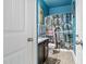 Cozy bathroom with blue walls, a shower with patterned curtain, and dark wood vanity at 201 Blue Heron Dr, Youngsville, NC 27596