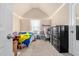 Bright bedroom with sloped ceilings, a cozy bed, and functional desk space at 201 Blue Heron Dr, Youngsville, NC 27596