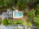 Aerial image of the community pool and clubhouse area surrounded by mature landscaping and trees at 201 Blue Heron Dr, Youngsville, NC 27596