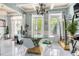 Dining area with glass table, stylish chairs, and natural light at 201 Blue Heron Dr, Youngsville, NC 27596