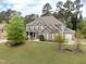 Beautiful two-story brick home featuring a well-maintained lawn and a inviting front porch at 201 Blue Heron Dr, Youngsville, NC 27596