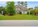 Charming two-story brick home with a well-manicured lawn and lush landscaping at 201 Blue Heron Dr, Youngsville, NC 27596