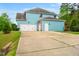 Spacious home exterior featuring a multi-car garage, ample driveway, and attractive architectural details at 201 Blue Heron Dr, Youngsville, NC 27596