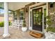 Covered front porch with white columns, rocking chairs, and decorative potted plants at 201 Blue Heron Dr, Youngsville, NC 27596