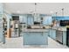 Spacious kitchen with blue cabinetry, stainless appliances, granite countertops, and center island at 201 Blue Heron Dr, Youngsville, NC 27596