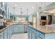 Charming kitchen featuring granite counters, stainless appliances, and blue cabinetry at 201 Blue Heron Dr, Youngsville, NC 27596