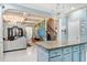 Bright kitchen with blue cabinets, granite countertops, chandelier, and large island at 201 Blue Heron Dr, Youngsville, NC 27596