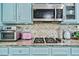 Close-up of well-organized kitchen appliances and a stone tiled backsplash at 201 Blue Heron Dr, Youngsville, NC 27596