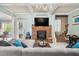 Cozy living room with a stone fireplace, plush seating, and marble flooring at 201 Blue Heron Dr, Youngsville, NC 27596