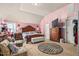 Spacious bedroom with a unique pink striped accent wall, plush carpeting, and coordinated furnishings at 201 Blue Heron Dr, Youngsville, NC 27596