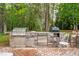 Outdoor kitchen featuring stainless steel appliances and stone accents at 201 Blue Heron Dr, Youngsville, NC 27596