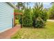 Cozy side yard featuring a brick path and an arbor with lush greenery and a decorative fence at 201 Blue Heron Dr, Youngsville, NC 27596