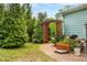 Landscaped walkway with a trellis, brick path, and verdant greenery at 201 Blue Heron Dr, Youngsville, NC 27596