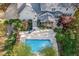 Aerial view of backyard featuring a swimming pool, screened in porch and large patio area at 206 Zapata Ln, Chapel Hill, NC 27517